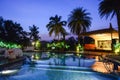 Poolside tropical holiday resort at dusk