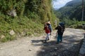 Poon Hill trek, Nepal - October 08, 2018: The Nepalese porters are carrying knapsacks Royalty Free Stock Photo