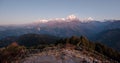 Poonhill view of Annapurnas. Warm pink and orange sunrise light over Annapurna mountain range with blue sky and beautiful clouds Royalty Free Stock Photo