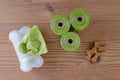 Poop bags with dog treats on wooden background, flat lay