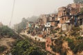 Poor area of Haridwar, India. House poor people on the hillside in front of a dirty river.