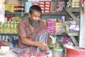 Poor Asian vendor selling betel leaf to the customer.
