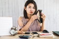 Poor Asian woman looking for money in empty wallet Royalty Free Stock Photo