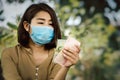 Poor Asian woman wearing protective mask hand holding less money having problem with low income Royalty Free Stock Photo