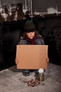 Poor beggar child on the street with blank sign Royalty Free Stock Photo