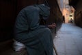 A poor beggar man in traditional Moroccan hoody djellaba outfit. fokiya, jellaba. Anonymous poor beggar in the street