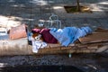 Poor Beggar sleeping on a Street in Athen Greece. Sleeping homeless or beggar old woman over cardboard box Royalty Free Stock Photo