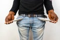 Poor Black man in jeans with empty pocket. Nigerian African American Man showing empty denim pockets on white background for joble Royalty Free Stock Photo