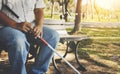 The poor blind Asian elder brother sat calmly holding a blind cane. sit on the bench tired