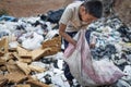 Poor boy collecting garbage in his sack to earn his livelihood, The concept of poor children and poverty