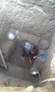 Poor boy of india diging the hole for toilet in village