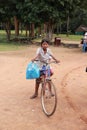 Poor cambodian kid playing with bicycle Royalty Free Stock Photo