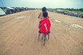 Poor cambodian kids racing with old bicycle