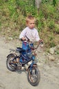 Poor child with a bicycle