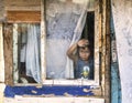 Poor child in a decaying house