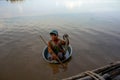 The poor child floats in a basin of dirty Tonle SAP lake