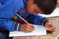 Poor child learning, writing