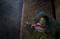 Poor child sleeping on grandparents house floor. Royalty Free Stock Photo