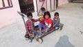 Poor Children playing on a cart