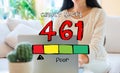 Poor credit score theme with woman using her laptop Royalty Free Stock Photo