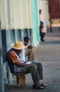 Poor Cuban old man capture portrait in traditional colorful alley with old colonial house, in old Havana, Cuba, America.