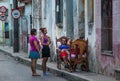 Poor Cuban old people capture portrait in traditional colorful colonial alley with old life style, in old city, Cuba, America.