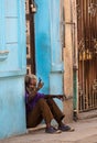 Poor Cuban old man capture portrait in traditional colorful colonial alley with old life style, in old Havana, Cuba, America.