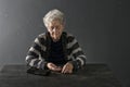 Poor elderly woman counting coins at table Royalty Free Stock Photo