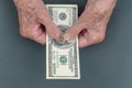 Poor elderly woman is counting some American Dollars in her hand. wrinkled Hands of an old woman. Counting money, economy concept Royalty Free Stock Photo