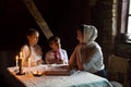 Poor family at the table. Mother gave the children the last piece of bread