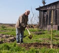 Poor farmer hoeing vegetable