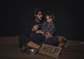 Poor father and daughter with HELP sign on floor