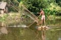 A village fisherman is throwing a net for fishing in a pond Royalty Free Stock Photo