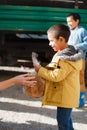 Poor gypsy kids getting bread from volunteers Royalty Free Stock Photo