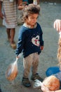 Poor gypsy kids getting bread from volunteers