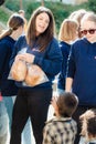 Poor gypsy kids getting bread from volunteers Royalty Free Stock Photo