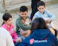 Poor gypsy kids getting bread from volunteers Royalty Free Stock Photo