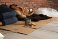 Poor homeless boy sleeping with his toy on floor Royalty Free Stock Photo