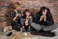 Poor homeless family sitting on floor Royalty Free Stock Photo