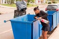 A Poor Homeless Indigenous Woman Picking through the Trash