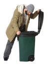 Poor homeless man digging in trash bin isolated