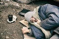 Poor homeless man lying on ground