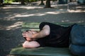 Poor homeless man sleeping on the wooden bench at park Royalty Free Stock Photo