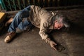 Poor homeless old man`s sitting on the floor feel sad stress no money sitting on sidewalk street, unemployed miserable street old Royalty Free Stock Photo