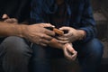 Poor homeless people sharing piece of bread, closeup Royalty Free Stock Photo