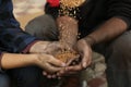 Poor homeless people taking wheat from donator outdoors Royalty Free Stock Photo