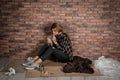 Poor homeless woman eating on floor Royalty Free Stock Photo