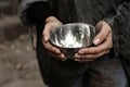 Poor homeless woman with empty bowl, closeup