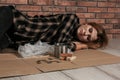 Poor homeless woman lying on floor Royalty Free Stock Photo