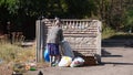 Poor Hungry Old Woman Rummage in Garbage Cans Searching for Food.